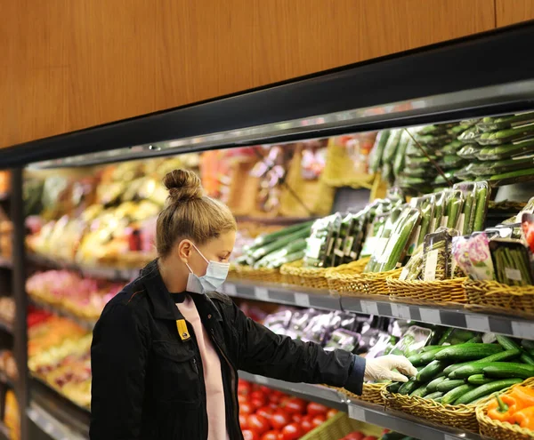 Supermarket shopping, face mask and gloves,Woman buying vegetables at the market