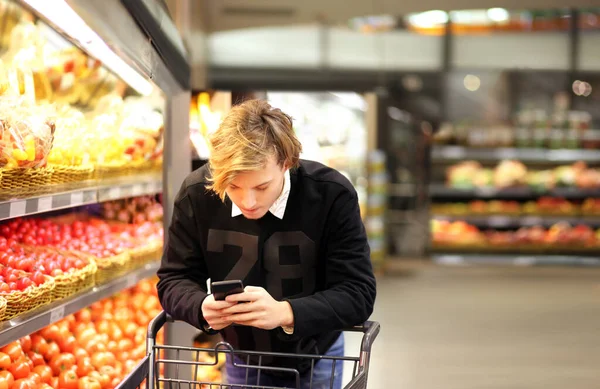 Young man buying vegetables at the market