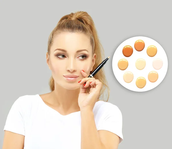 Contouring.Make up woman face.Foundation on white background