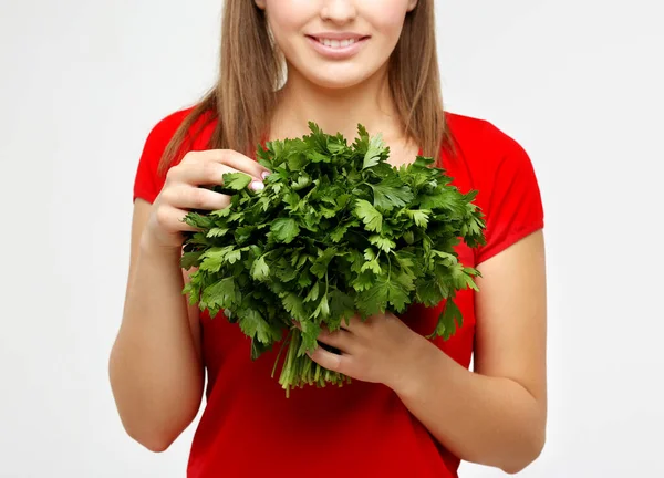 Woman with vegetable groceries .Young woman holding parsley