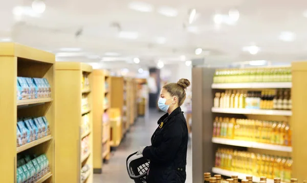 Supermarket shopping, face mask and gloves,Woman choosing a dairy products at supermarket