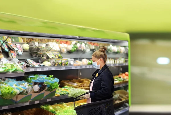 Supermarket shopping, face mask and gloves,Woman buying vegetables at the market