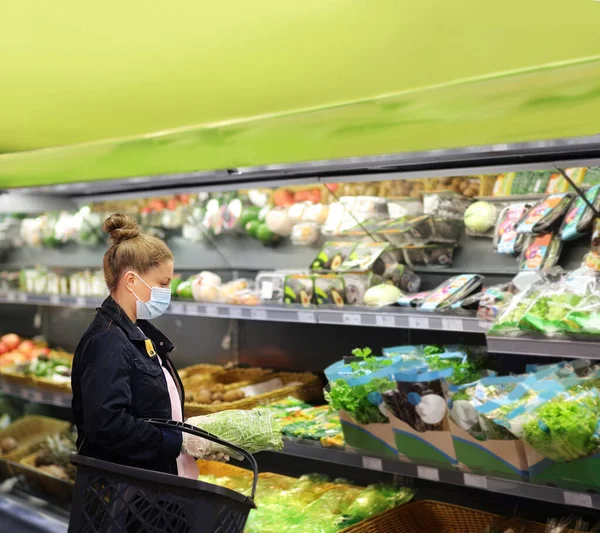 Supermarket shopping, face mask and gloves,Woman buying vegetables at the market