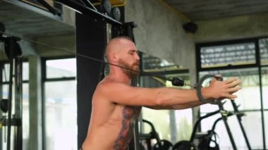 Arka Kollar Antrenman Sporcusu Güçlü Kas Sporcusu Dövmeli Adam kaslarını çalıştıran Vücut geliştiren yakışıklı Avrupalı Ayna ile beden eğitimi yapan     