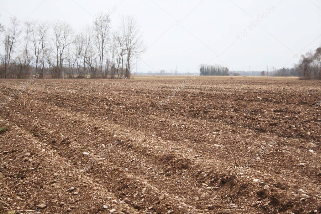 Plowed agricultural field on winter season. Agricultural field