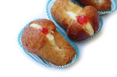 Geleneksel İtalyan tatlısının adı Bab with Rum. Beyaz arka planda izole edilmiş kremayla dolu. Beyaz üzerine Napoli çöreği