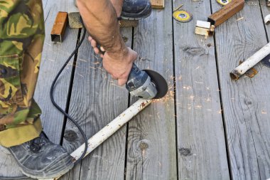 Metal bir elektrik değirmeni açık alanda çalışma. Elektrik kaynak için hazırlık.