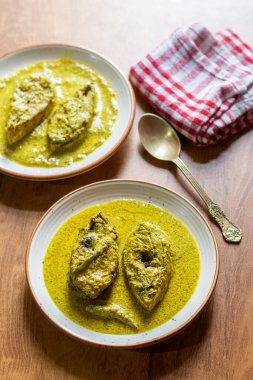 Hardal tohumlu Hilsa köri, keskin hardal ezmesi, baharat ve hardal yağı ile kaynatılmış taze balıkların yer aldığı geleneksel bir Bengali lezzetidir..