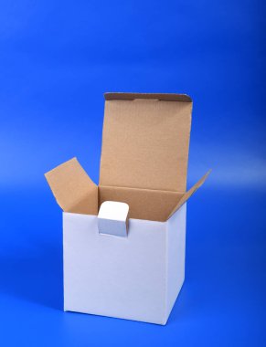 Mavi zemin üzerinde beyaz kare karton kutu