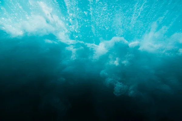 Breaking ocean wave is underwater. Ocean texture in underwater