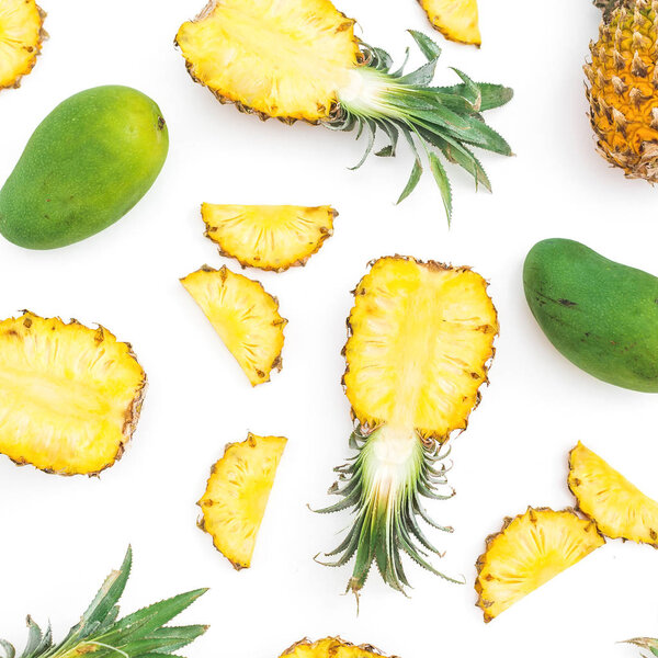 Tropical fruit pattern of pineapple and mango fruits on white background. Flat lay, top view. Food concept.