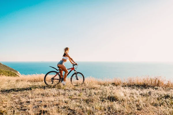 sportif kadın kırmızı dağ bisiklet üzerinde. Aktivite tatil kavramı 