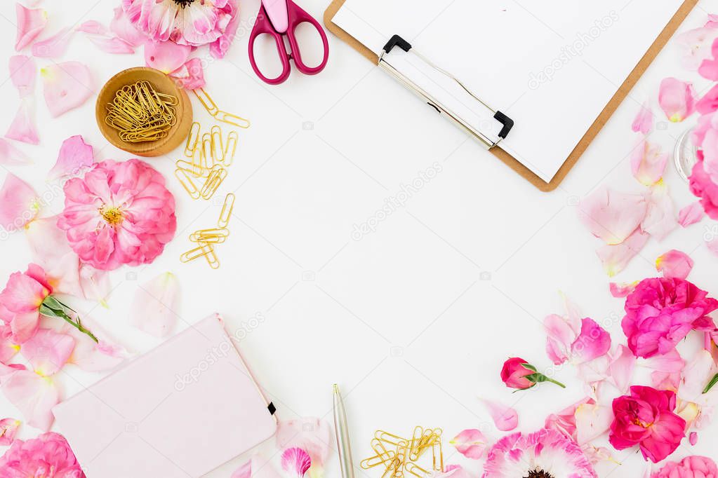 Workspace with clipboard and pastel roses with accessories isolated on white background, top view, Blogger concept  