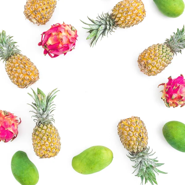 Fruit frame with pineapples, mango and dragon fruits on white background. Flat lay, top view. Food background.