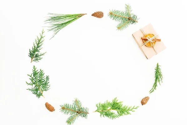 Christmas holidays frame with gift box, every green branches and pine cones on white background. New year composition. Flat lay. Top view