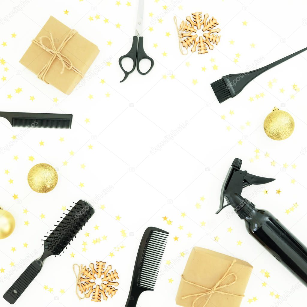 Christmas hairdresser composition with spray, combs, scissors and gift box with decoration on white background. Stylish concept. Flat lay, top view