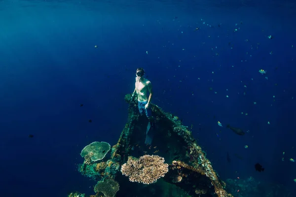 Free diver man swim at USS Liberty Wreck, Bali