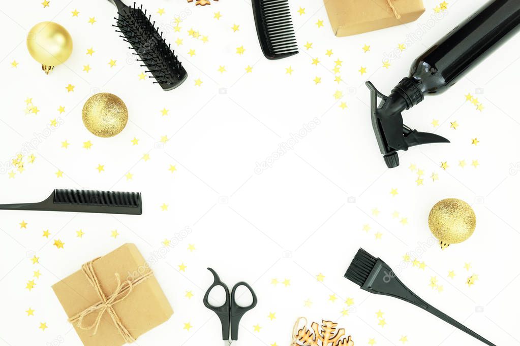 Christmas hairdresser frame composition with spray, combs, scissors and gift box with balls on white background. Flat lay, top view