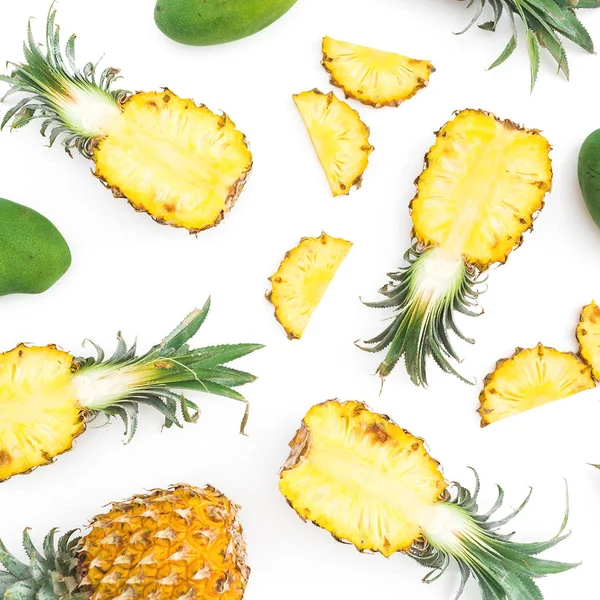 Tropical food pattern made of pineapple and mango fruits on white background. Flat lay, top view