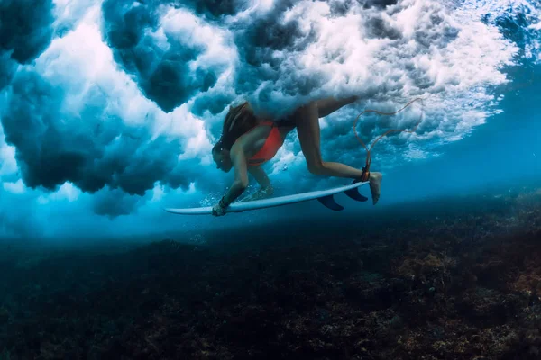 大きなクラッシュの波の下にダイビング サーフィン ボードを持つサーファー女性 — ストック写真