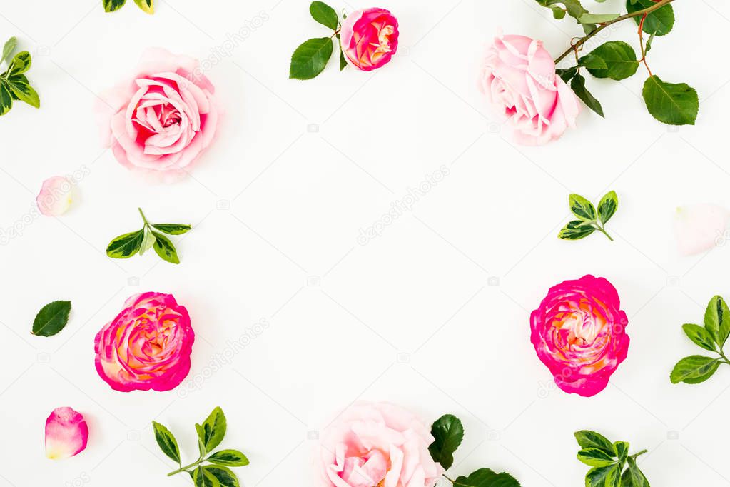 Spring time frame background. Floral composition of pastel pink roses flowers and green leaves on white background. Flat lay, top view.