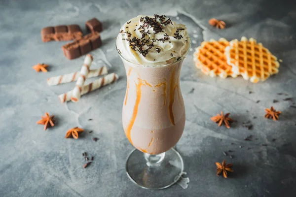 Chocolate milkshake with whipped cream and chocolate. Sweet drink with cookies