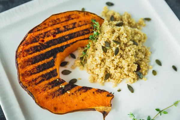 Grilled pumpkin with sprouted millet and pumpkin grains.