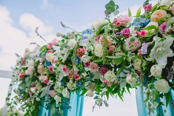 Floral decorations for wedding ceremony. Wedding arch with beautiful flowers.