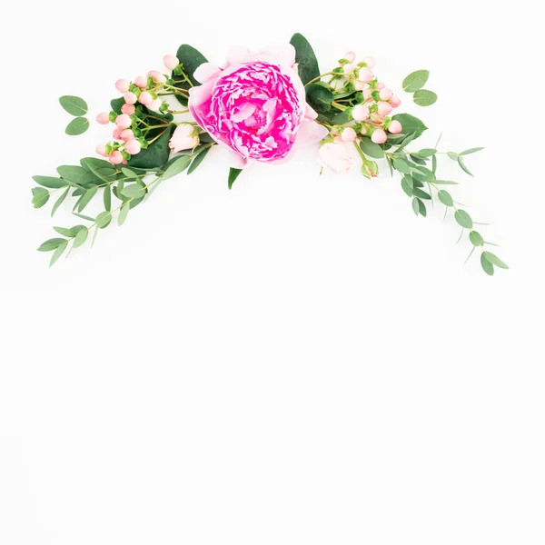 Floral frame of pink peony and roses flowers and eucalyptus branches on white background. Flat lay, top view