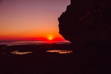 Bali rock ve parlak günbatımı ve gündoğumu okyanus.