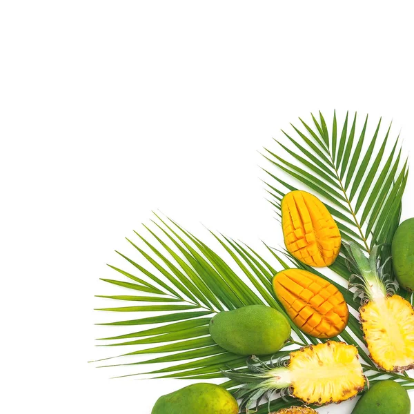 Tropical fruits background of pineapple and mango fruits on white background. Flat lay, top view. Copy space