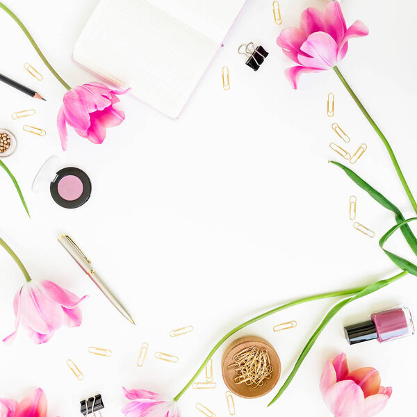 Concept with clipboard, notebook, pen, pink tulip flowers and cosmetics on white background. Flat lay, top view