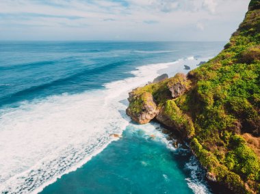 Aerial view of rocky coast and ocean in Bali, Indonesia. clipart