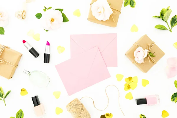 Flowers, envelope, cosmetics and gifts on white background. Flat lay, top view. Valentines day concept