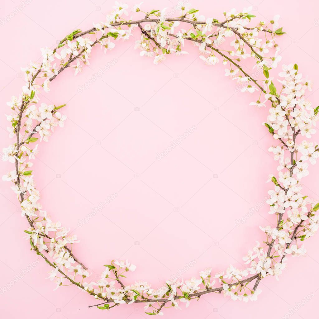 Floral frame with spring flowers on pastel background. Flat lay, top view. Spring time background.