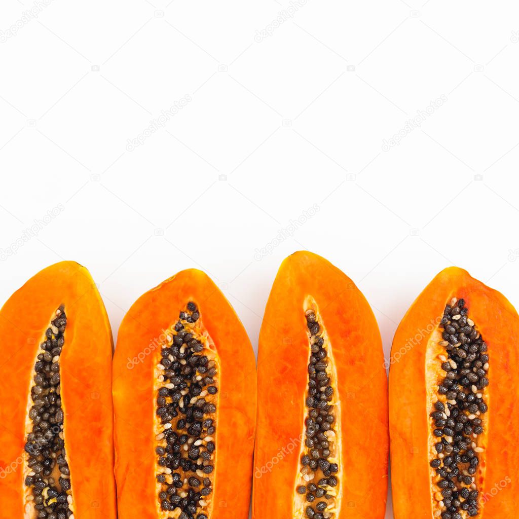 Slices of tasty papaya on white background. Flat lay. Top view. Fruit concept