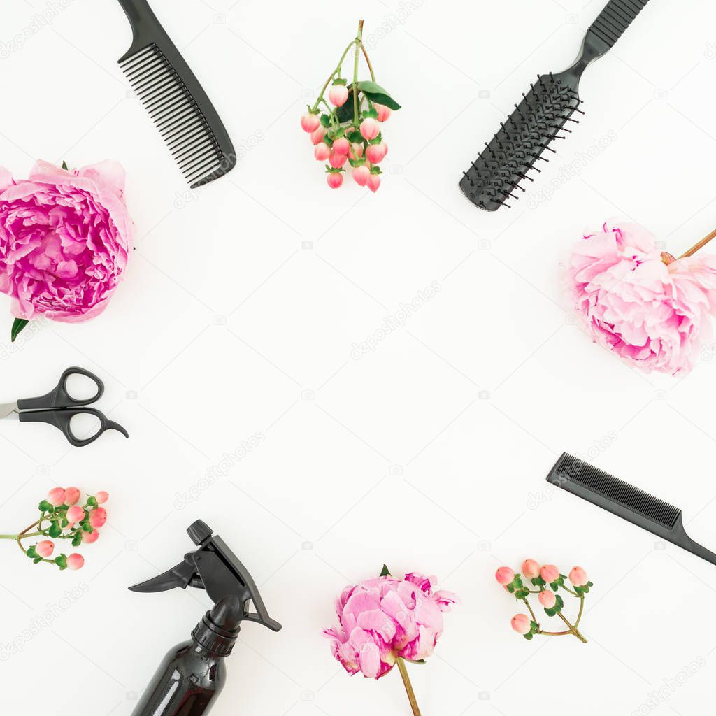Hairdresser concept with spray, scissors, combs and peonies flowers on white background. Flat lay