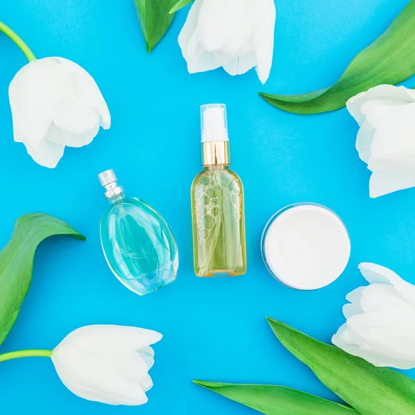 Kadınsı Parfüm Pembe Ruj Mavi Arka Planda Beyaz Lale Çiçekler — Stok fotoğraf