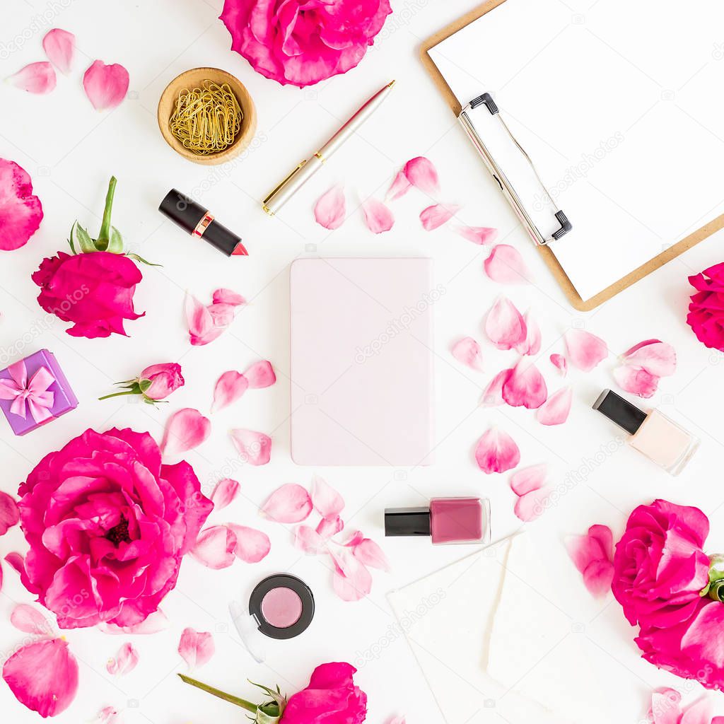 Workspace with clipboard, pastel roses, cosmetics and accessories on white background. Flat lay, top view