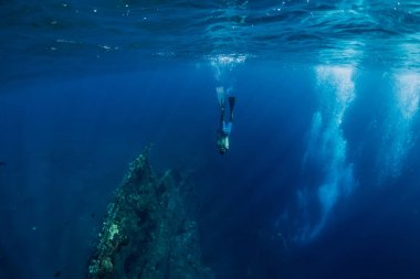 Freediver man dive underwater at shipwreck in Bali. Freediving in ocean clipart