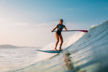 12 Nisan 2019. Bali, Endonezya. Okyanus dalgası üzerinde Paddle sörfçü binmek Stand Up. Bali dalgalar sörf Paddle Stand Up