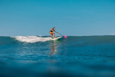 12 Nisan 2019. Bali, Endonezya. Okyanus dalgası üzerinde Paddle sörfçü binmek Stand Up. Bali dalgalar sörf Paddle Stand Up