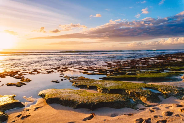 Beach with blue ocean and sunset sky