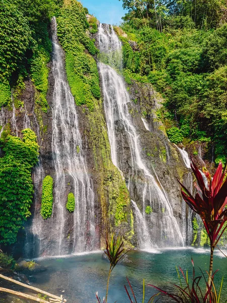 Waterfall with crystal water and rainbow in Bali