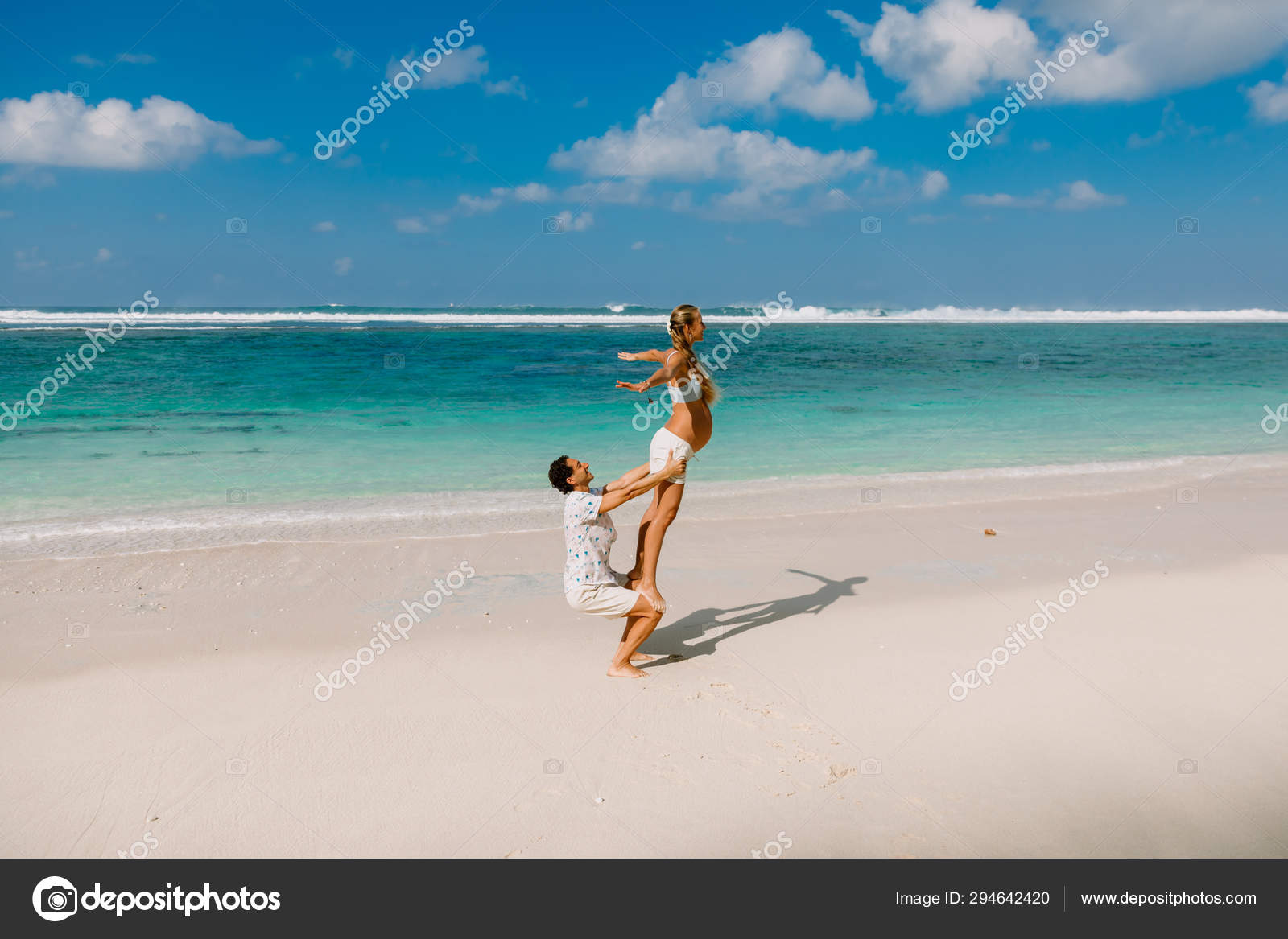 Pregnant woman with husband expecting baby with yoga pose at bea Stock  Photo by ©Keola 294642420