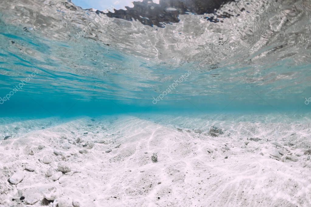 Blue ocean with white sand bottom underwater in Hawaii