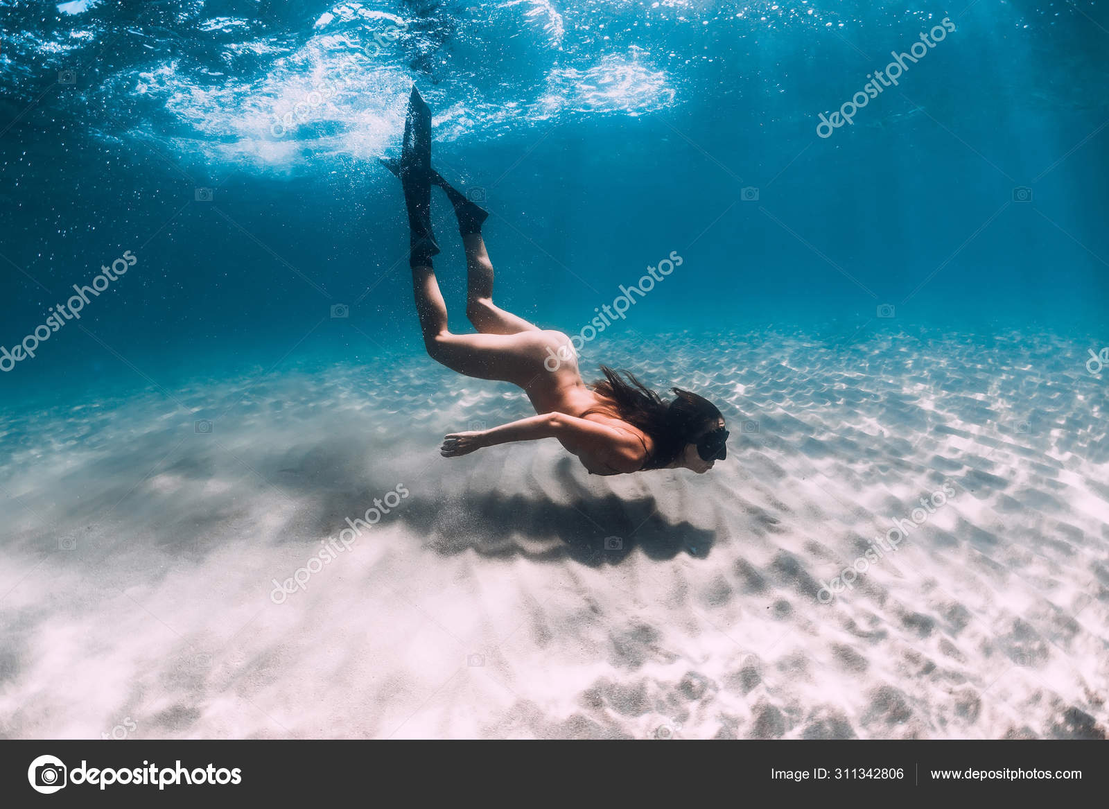 Naked woman freediver glides over sandy bottom. Beautiful woman Stock Photo  by ©Keola 311342806