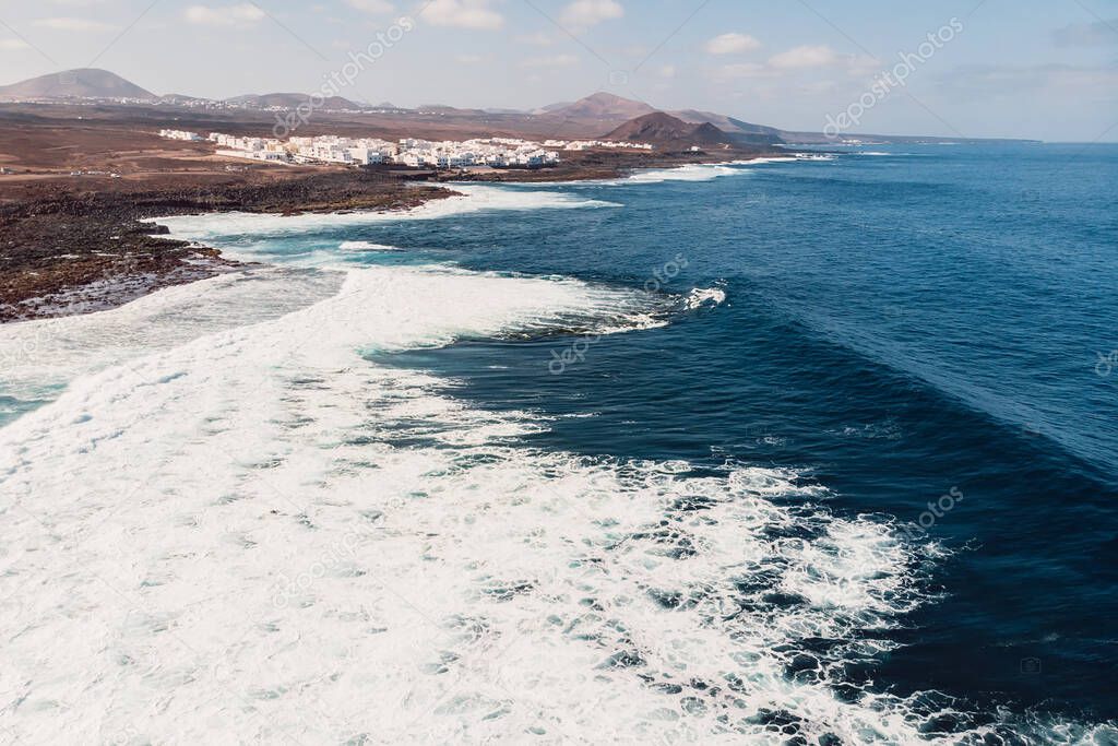 Aerial view of La Santa beach with ocean wave and village in Lanzarote, Canary islands