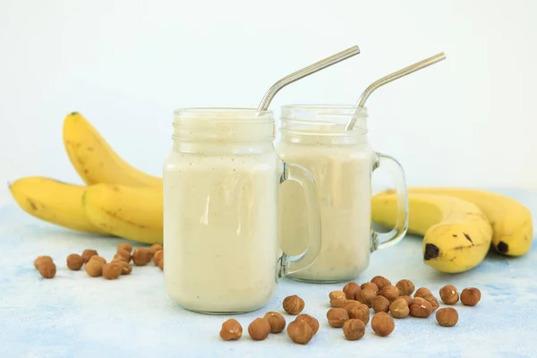Banana smoothie with banana and nuts. Vegetarian food, diet and healthy concept