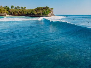 Okyanusta fıçı dalgası ve arka planda uçurum. Mavi dalgaların havadan görüntüsü